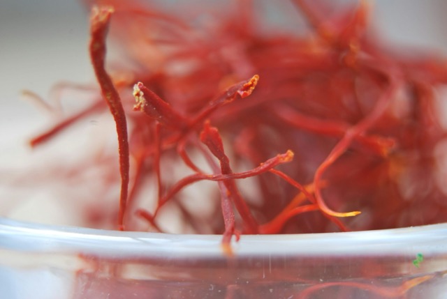 Premium Iranian saffron threads, also called Persian saffron or Irani kesar, in a glass bowl, highlighting their rich red color and natural quality.